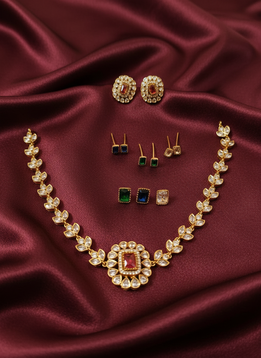 Gold jewelry collection on maroon satin background