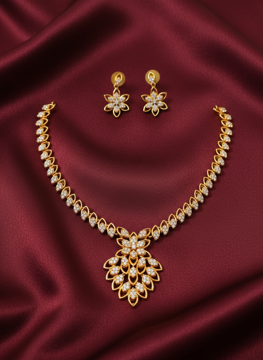 Gold jewelry set on maroon satin background