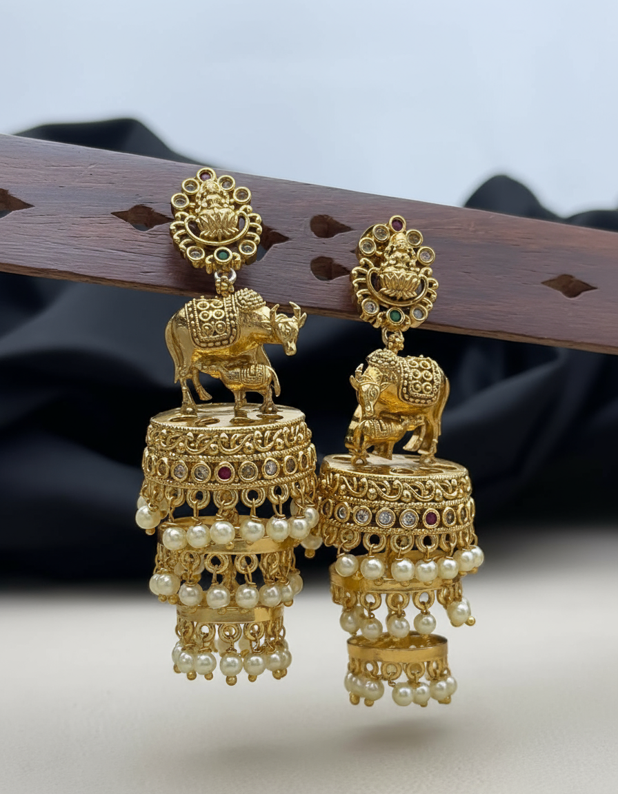 Gold jhumka earrings on earring stand