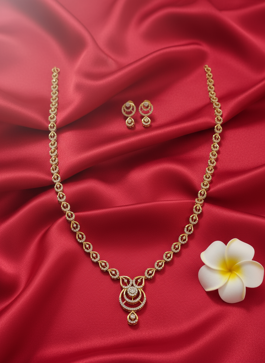 Gold necklace set on red satin cloth with flower