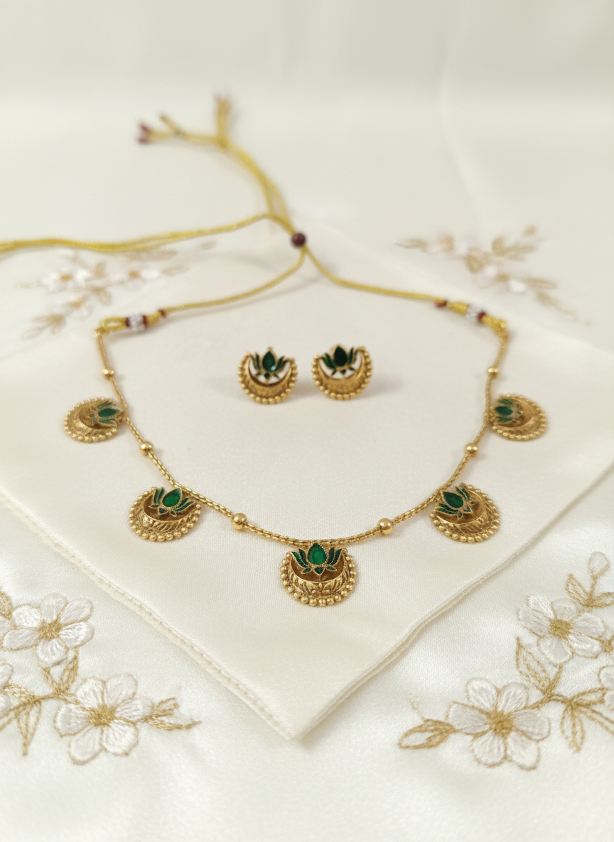 Green stone necklace set on cream satin with flowers