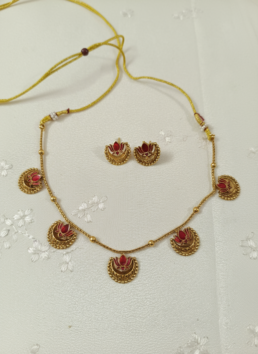 Necklace set on cream satin with flowers
