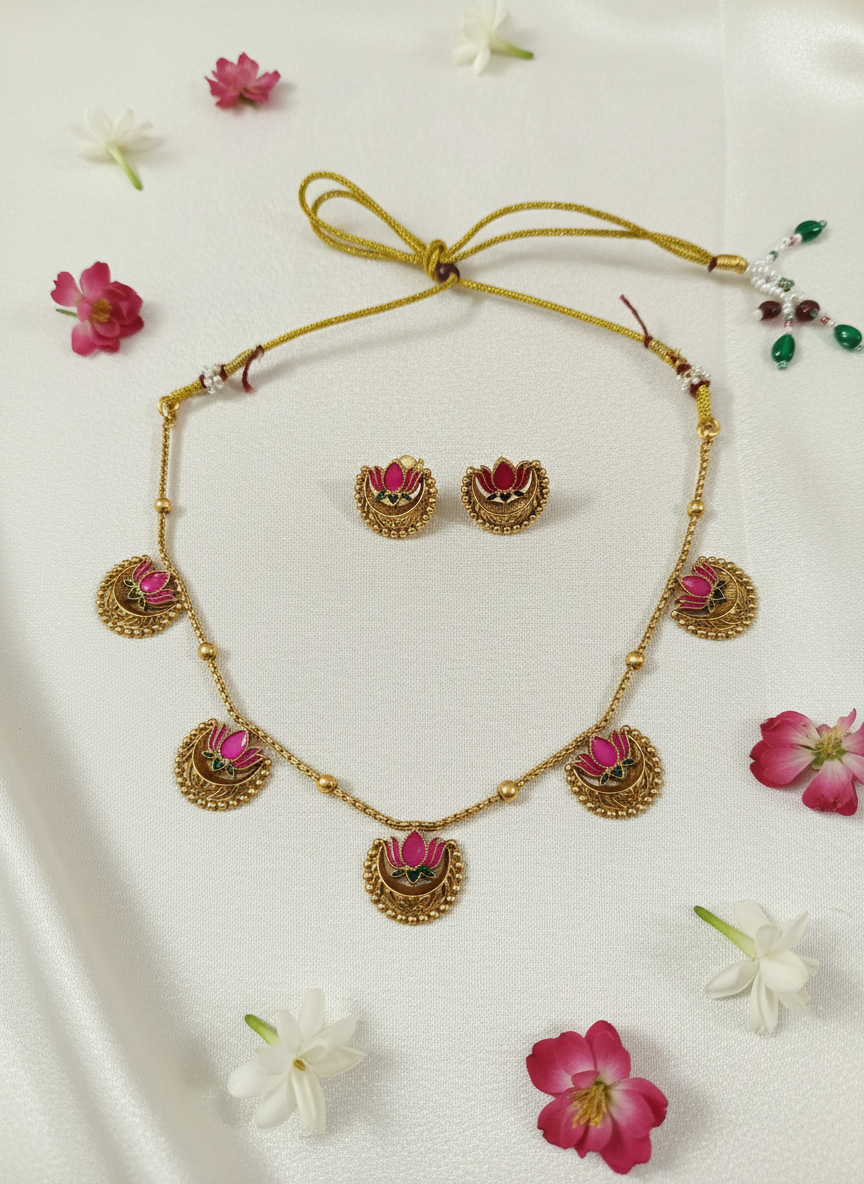 Pink stone necklace set on cream satin with flowers