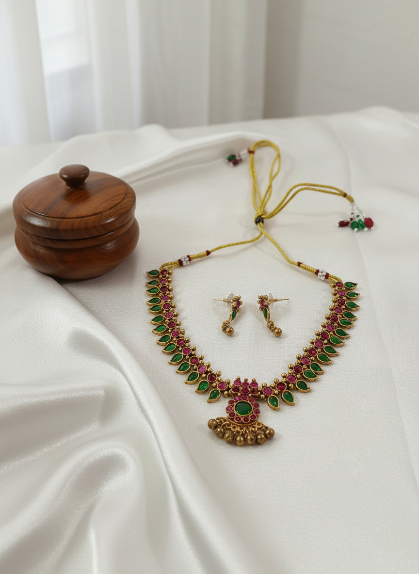 Temple jewelry necklace on white satin with kumkum box