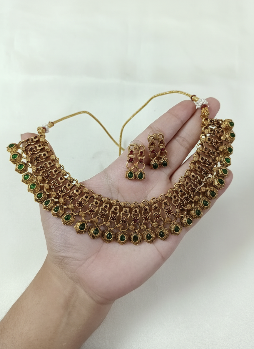 Temple jewelry set held in hand on white satin